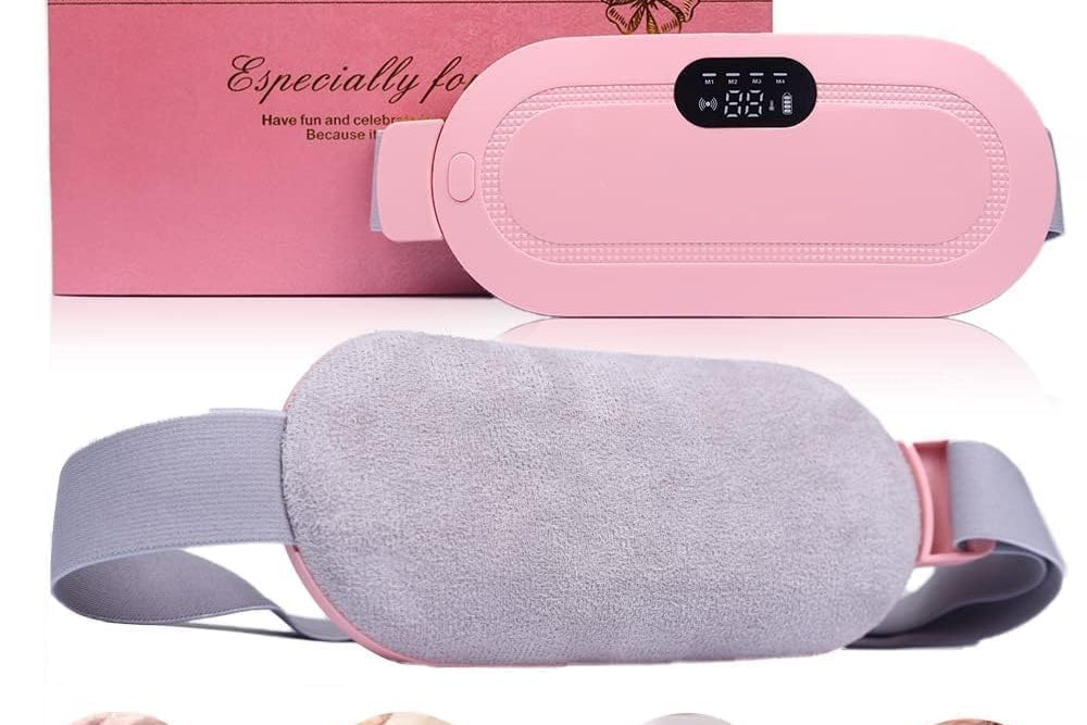 Pink and gray waist massage belt with digital display and packaging on a white background.